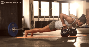 crossfit girl push ups on kettlebells in summer