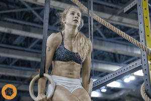 crossfit female performs ring muscle up