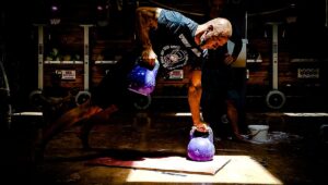 man performs hard kettlebell workout with gorilla cleans Kettlebell Exercises for Building Muscle