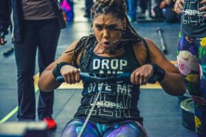 woman training hard on indoor rowing machine