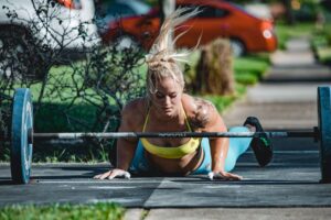 crossfit athlete bar facing burpees