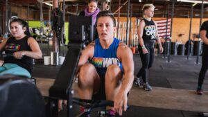 member of LGBTQ+ nonprofit the OUT Foundation does workout with support in the background