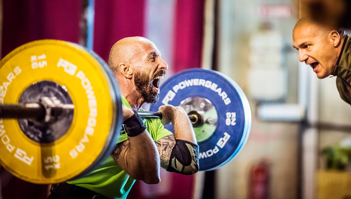 man performs different rep ranges of front squats in the gym