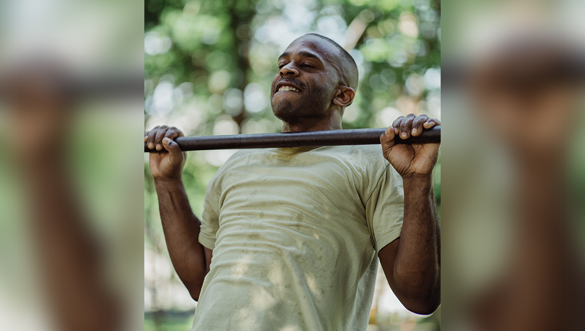 man performs a pull-up Dumbbell Back Exercises