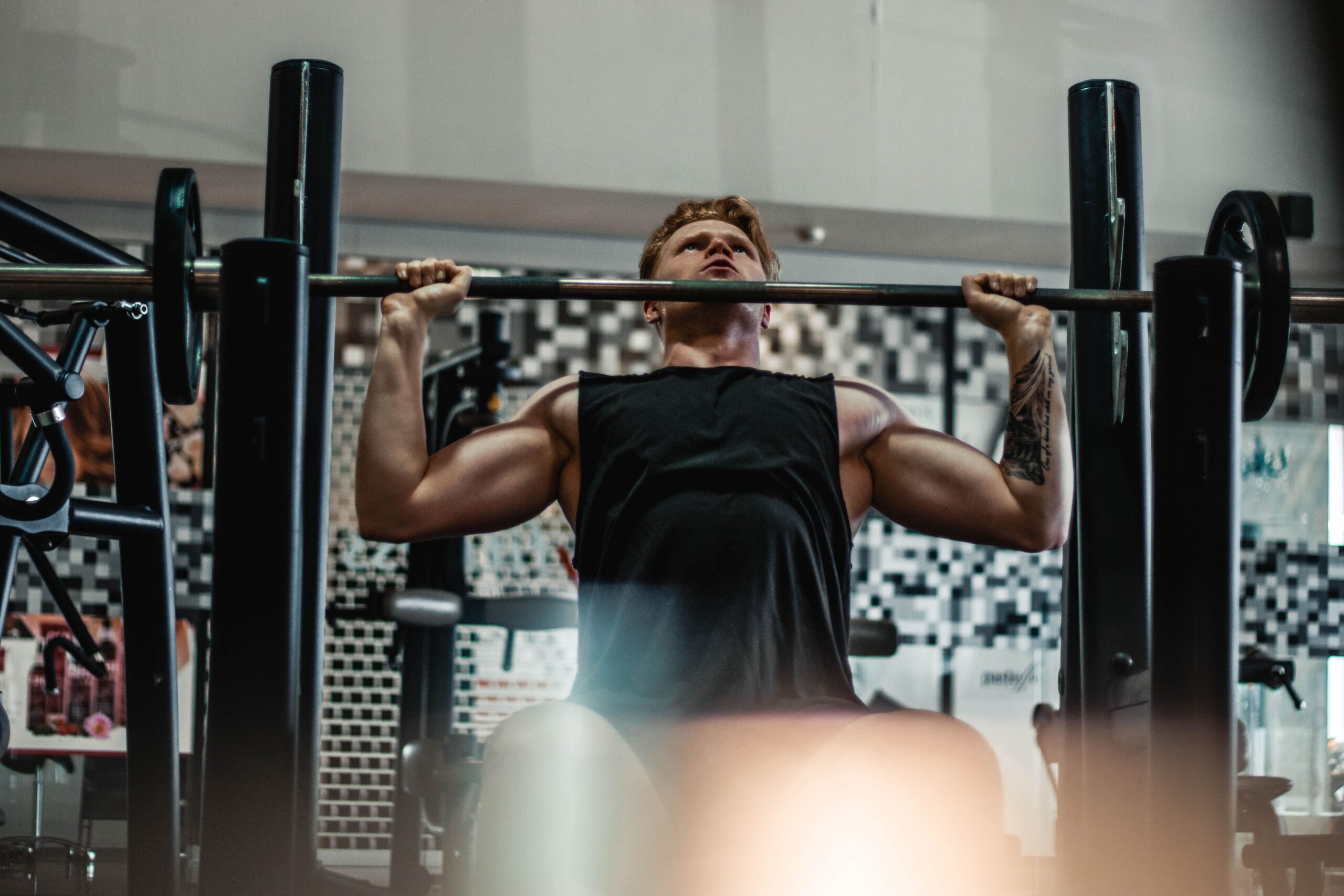 man lifts barbell