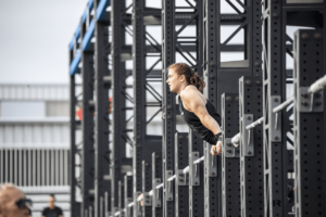 teen athlete does muscle up at crossfit games Random WOD Generator