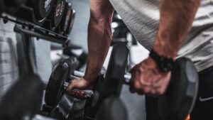 Man picking up dumbbells