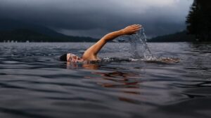 Person in lake swimming Fitness Challenges