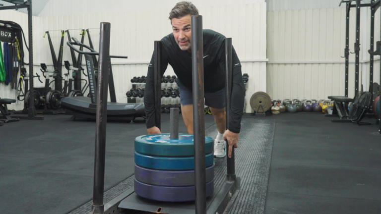 Gethin Jones doing a sled push mid training